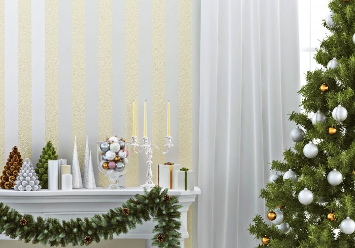 white mantel decorated with garland and candles